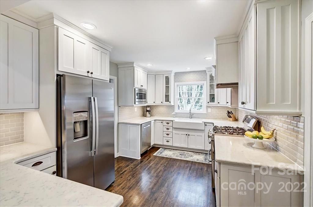 3021 Eastburn Road Charlotte, NC 28210 - Photo 20 of 48 a kitchen with white cabinets and stainless steel appliances