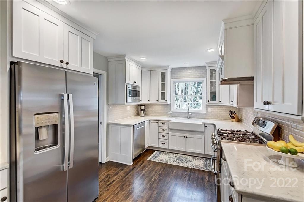 3021 Eastburn Road Charlotte, NC 28210 - Photo 21 of 48 a kitchen with a refrigerator a sink cabinets and wooden floor