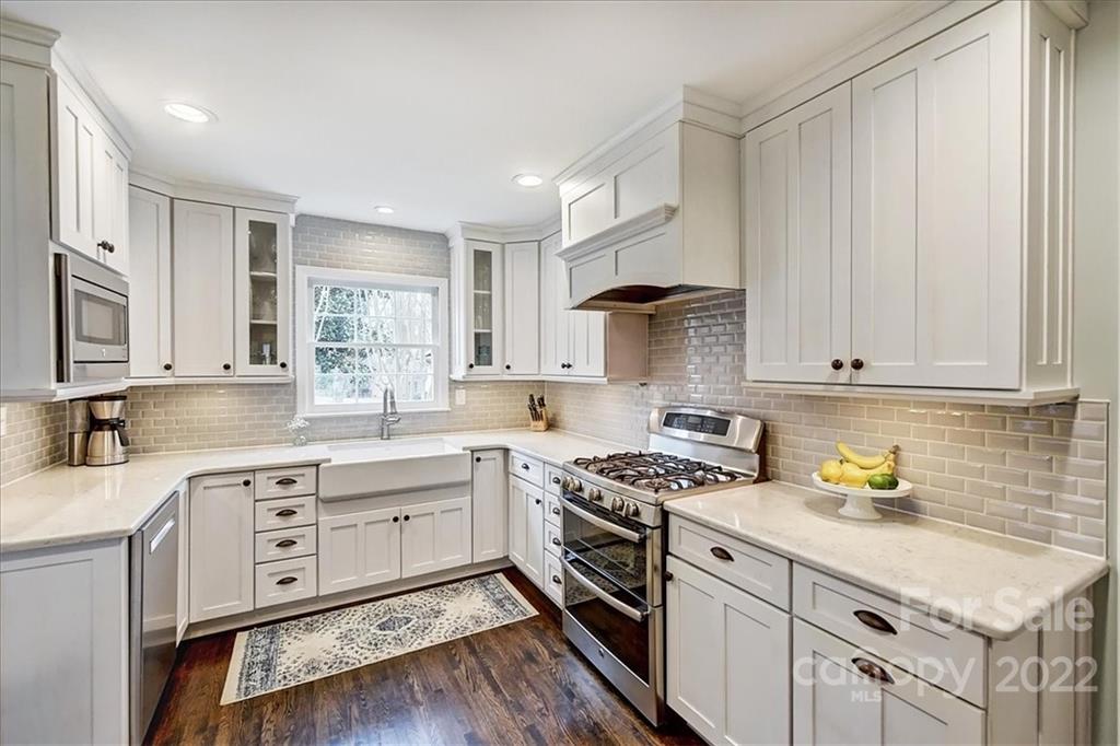 3021 Eastburn Road Charlotte, NC 28210 - Photo 22 of 48 a kitchen with white cabinets stainless steel appliances and sink