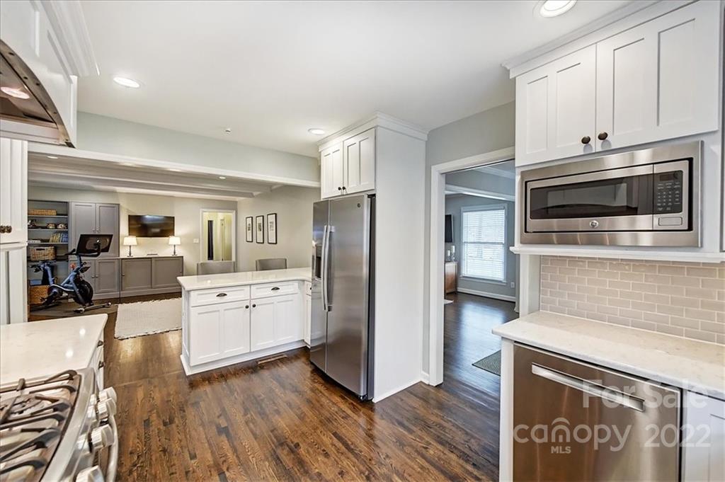 3021 Eastburn Road Charlotte, NC 28210 - Photo 24 of 48 a kitchen with stainless steel appliances granite countertop a refrigerator oven a stove top oven and white cabinets