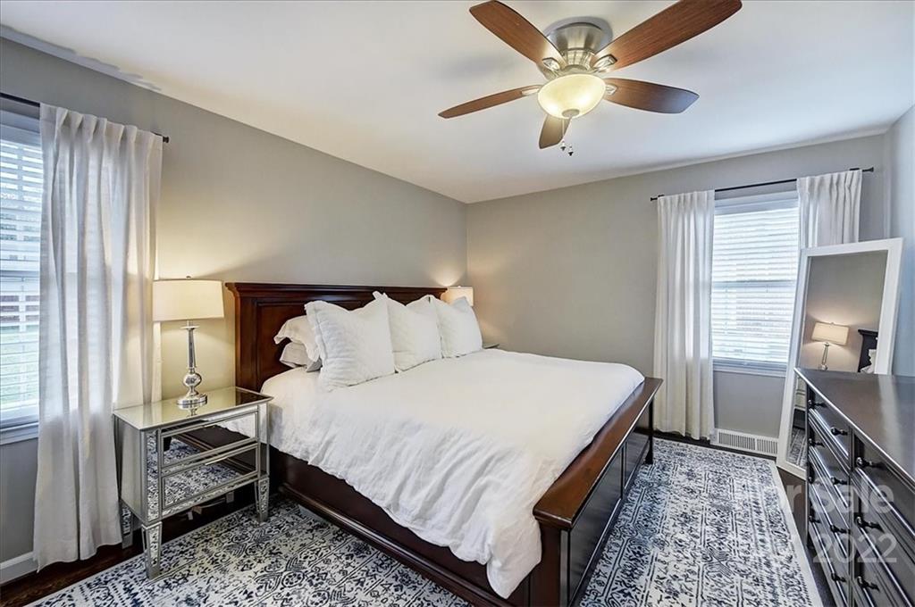 3021 Eastburn Road Charlotte, NC 28210 - Photo 28 of 48 a bed room with a bed and a chandelier