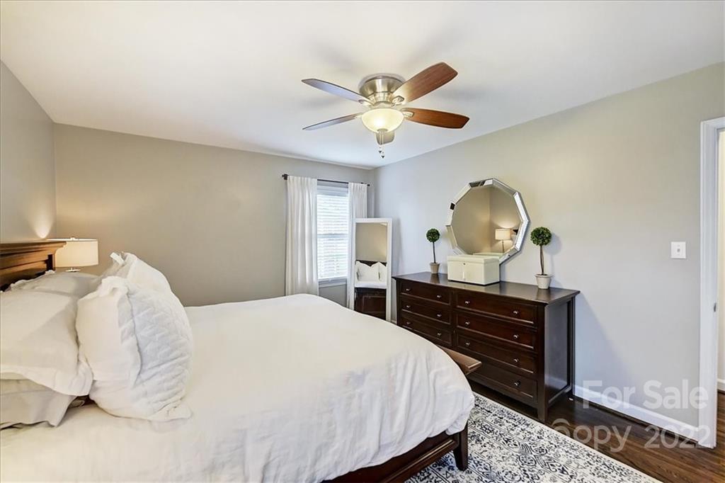 3021 Eastburn Road Charlotte, NC 28210 - Photo 29 of 48 a bedroom with a bed and a chandelier