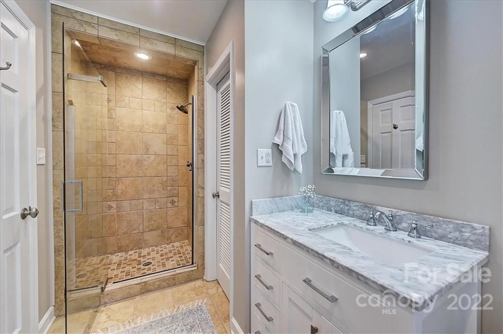 3021 Eastburn Road Charlotte, NC 28210 - Photo 30 of 48 a bathroom with a granite countertop sink mirror and shower