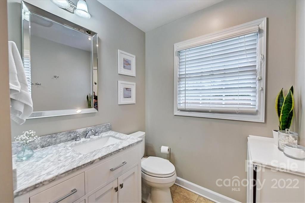 3021 Eastburn Road Charlotte, NC 28210 - Photo 32 of 48 a bathroom with a granite countertop sink toilet and mirror