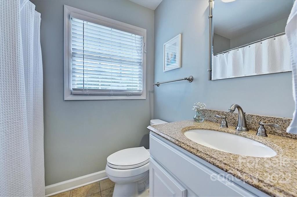 3021 Eastburn Road Charlotte, NC 28210 - Photo 34 of 48 a bathroom with a granite countertop sink and a toilet