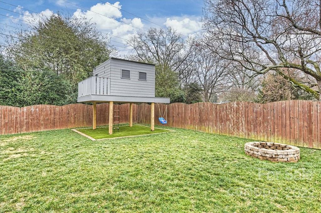 3021 Eastburn Road Charlotte, NC 28210 - Photo 38 of 48 a view of a backyard with a small cabin and a chair