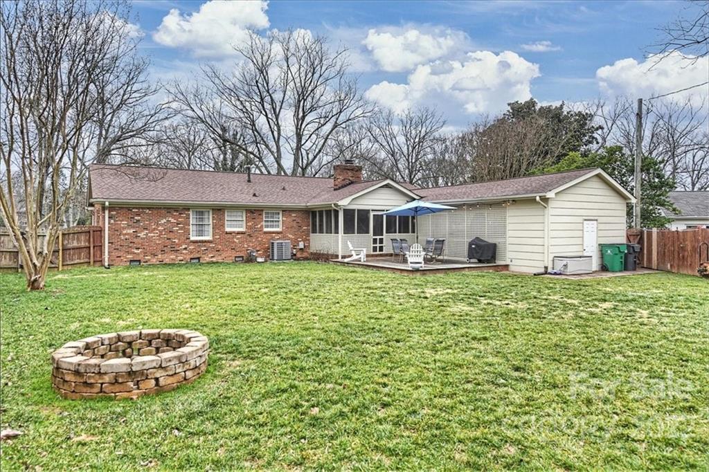 3021 Eastburn Road Charlotte, NC 28210 - Photo 39 of 48 a front view of a house with a garden and trees