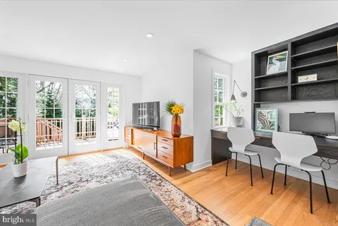 a living room with furniture and a floor to ceiling window