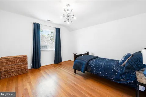 a view of a bedroom with furniture window and wooden floor