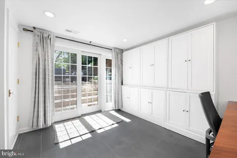 a hallway with a large window and closet