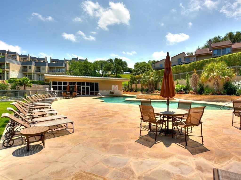 2918 Ranch Road 620 North, Unit X205 Austin, TX 78734 - Photo 19 of 23 a view of a patio with a table chairs and a patio