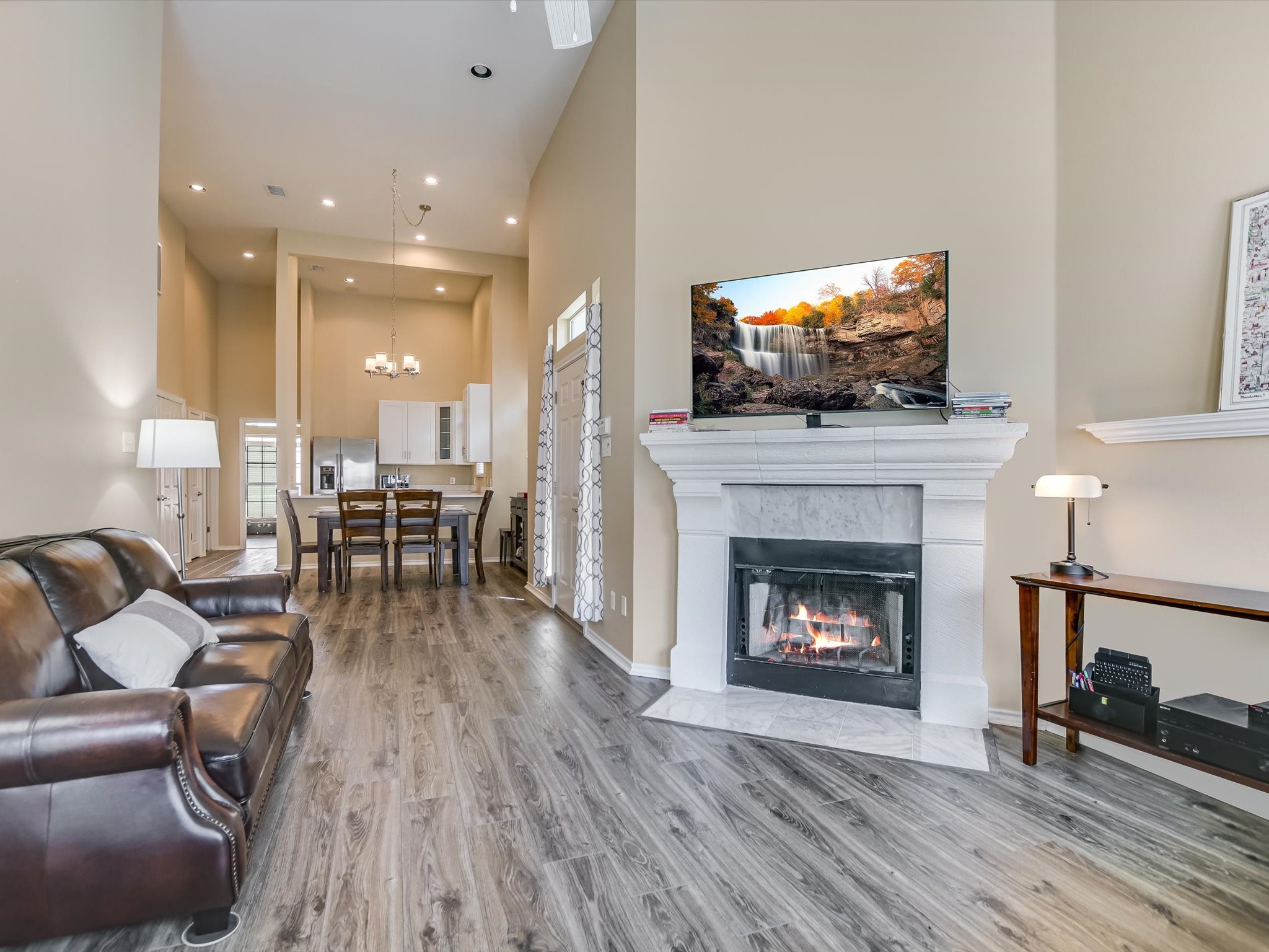 2918 Ranch Road 620 North, Unit X205 Austin, TX 78734 - Photo 4 of 23 a living room with furniture a flat screen tv and a fireplace