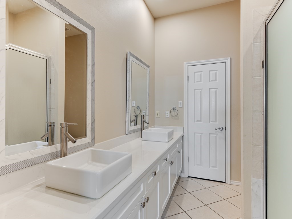 2918 Ranch Road 620 North, Unit X205 Austin, TX 78734 - Photo 8 of 23 a spacious bathroom with a double vanity sink mirror and a bathtub