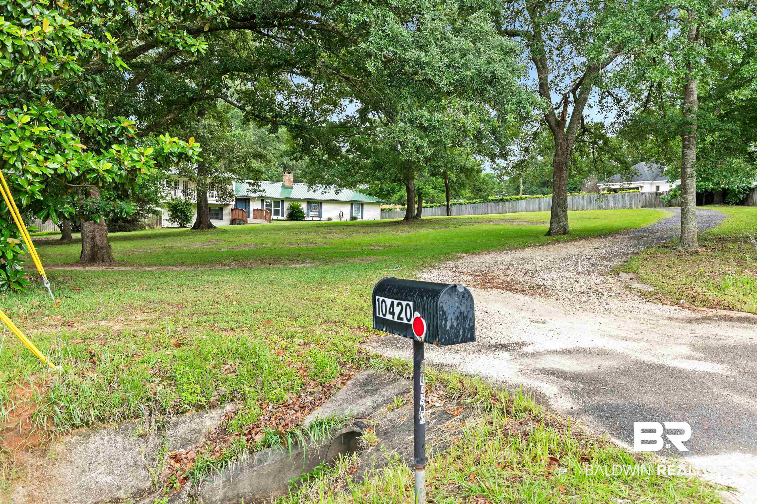10420 Johnson Road South Mobile, AL 36695 - Photo 3 of 75 Expansive front lawn with mature trees and a long gravel driveway leading to the residence