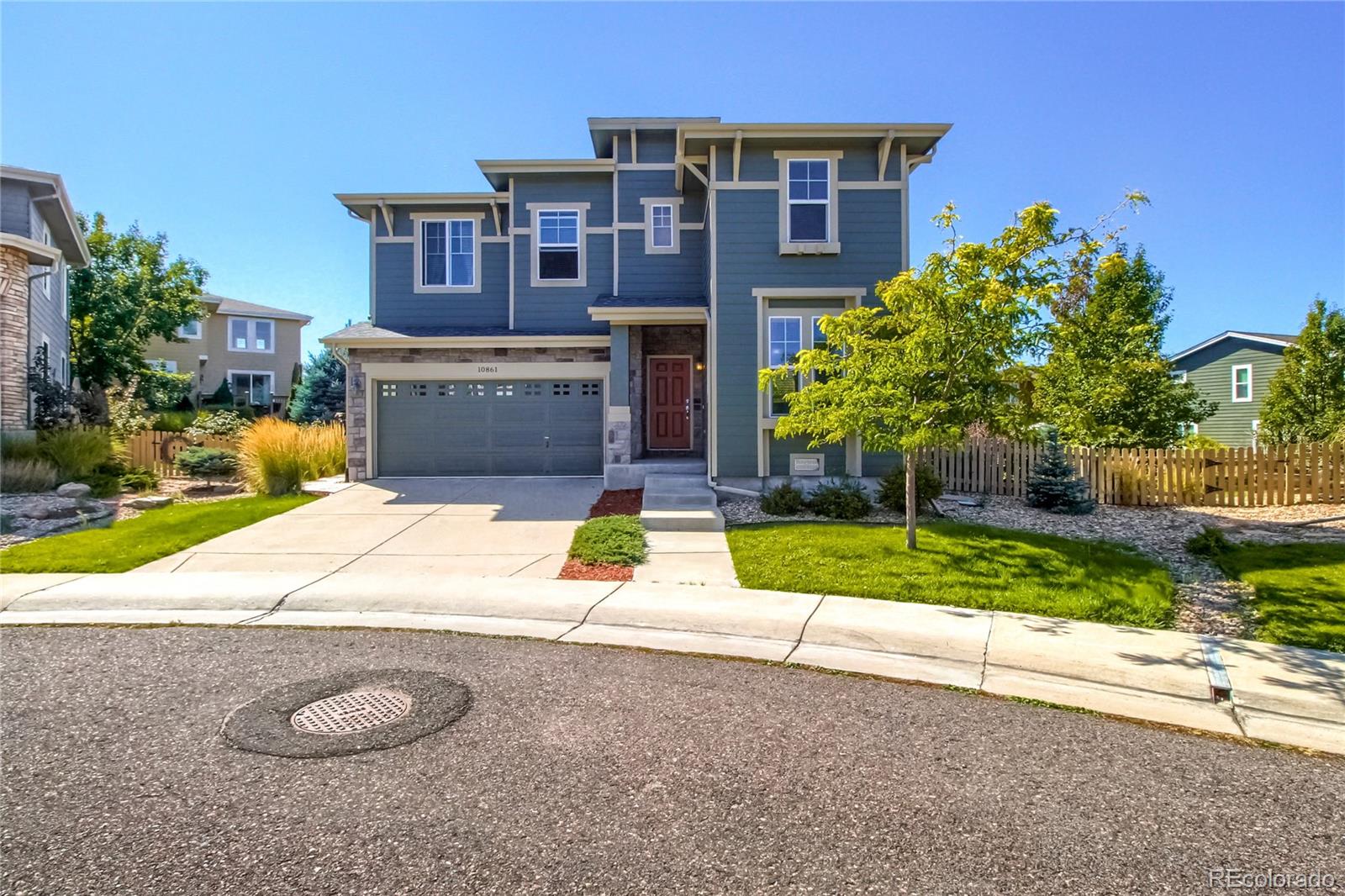10861 Brooklawn Road Highlands Ranch, CO 80130 - Photo 1 of 30 a house with a yard and a sitting space