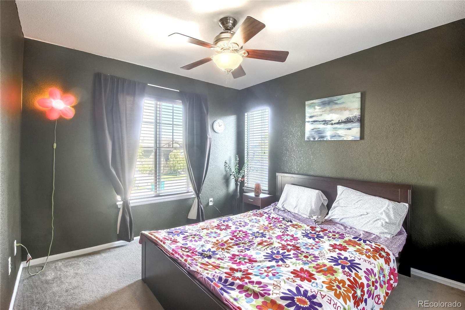 10861 Brooklawn Road Highlands Ranch, CO 80130 - Photo 16 of 30 a bedroom with a bed and a window