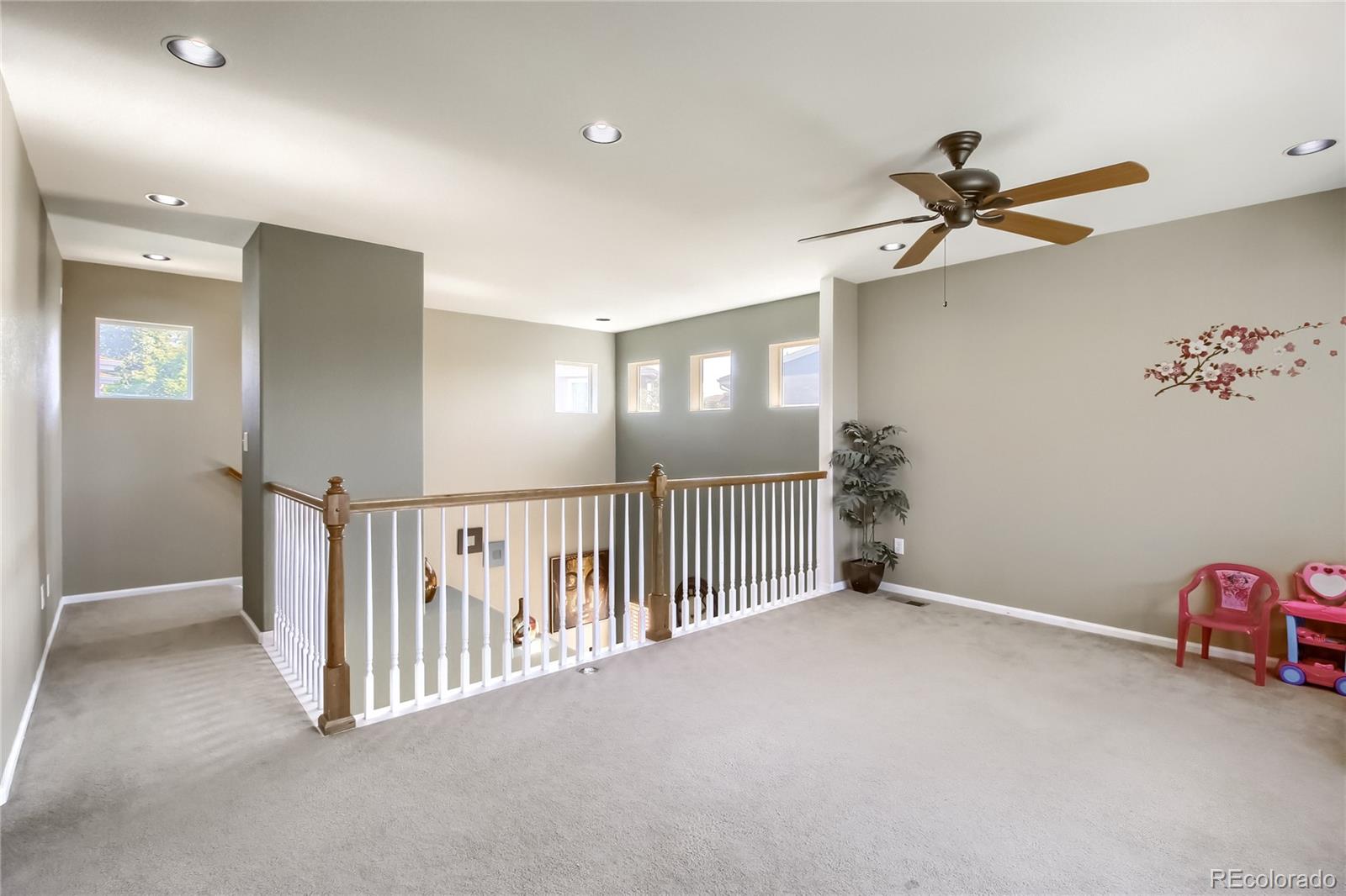 10861 Brooklawn Road Highlands Ranch, CO 80130 - Photo 19 of 30 a view of a hallway with a chandelier