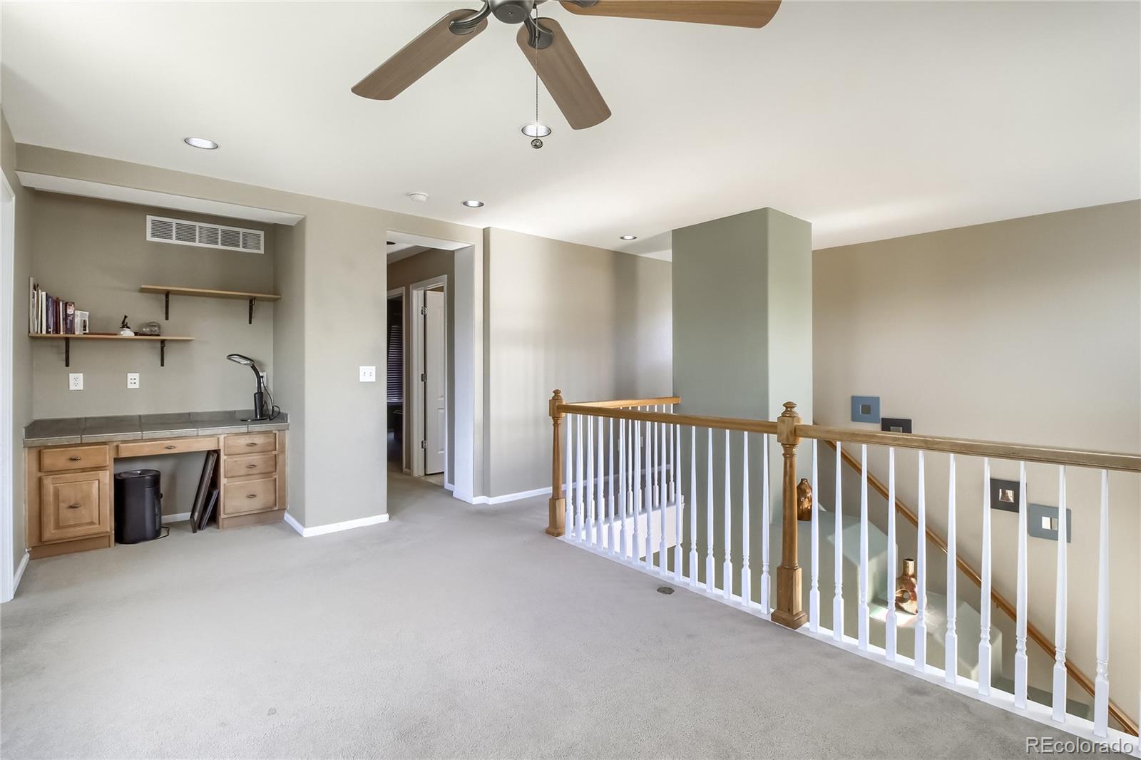 10861 Brooklawn Road Highlands Ranch, CO 80130 - Photo 21 of 30 a view of an empty room and kitchen with a sink