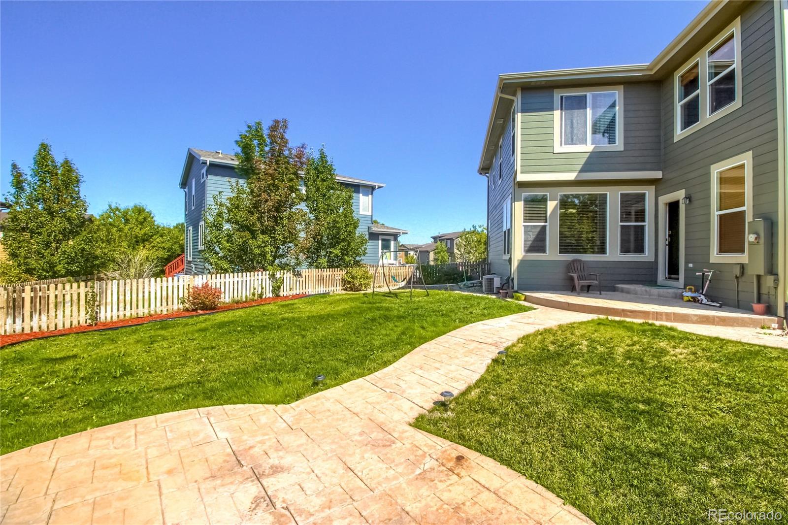10861 Brooklawn Road Highlands Ranch, CO 80130 - Photo 25 of 30 a view of a house with a yard patio and swimming pool