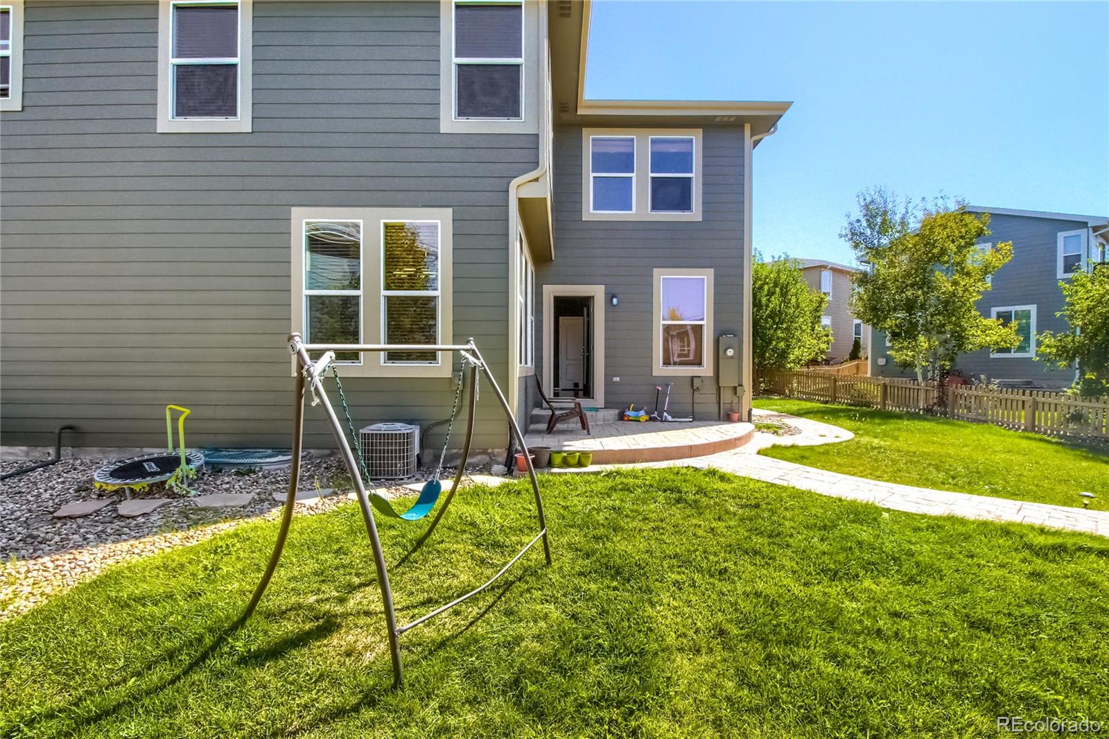 10861 Brooklawn Road Highlands Ranch, CO 80130 - Photo 26 of 30 a view of a house with backyard sitting area and swimming pool