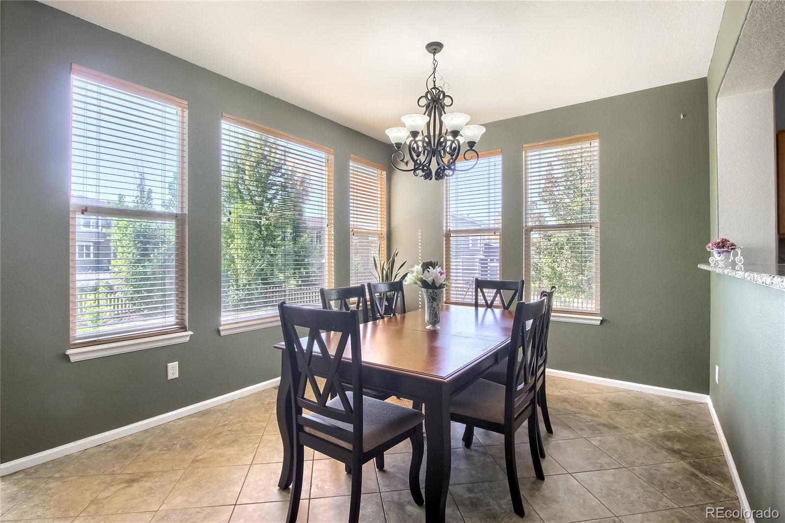 10861 Brooklawn Road Highlands Ranch, CO 80130 - Photo 9 of 30 a view of a dining room with furniture window and outside view