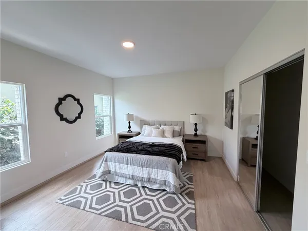 a bedroom with a large bed and a window