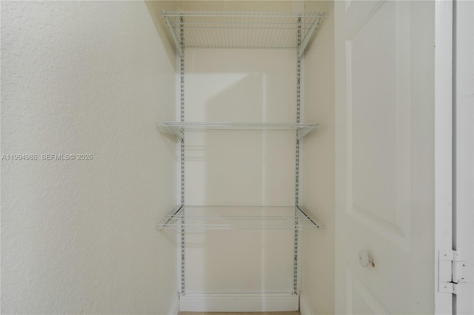 15250 Southwest 154th Terrace, Unit A Miami, FL 33187 - Photo 15 of 16 a bathroom with a glass shower door