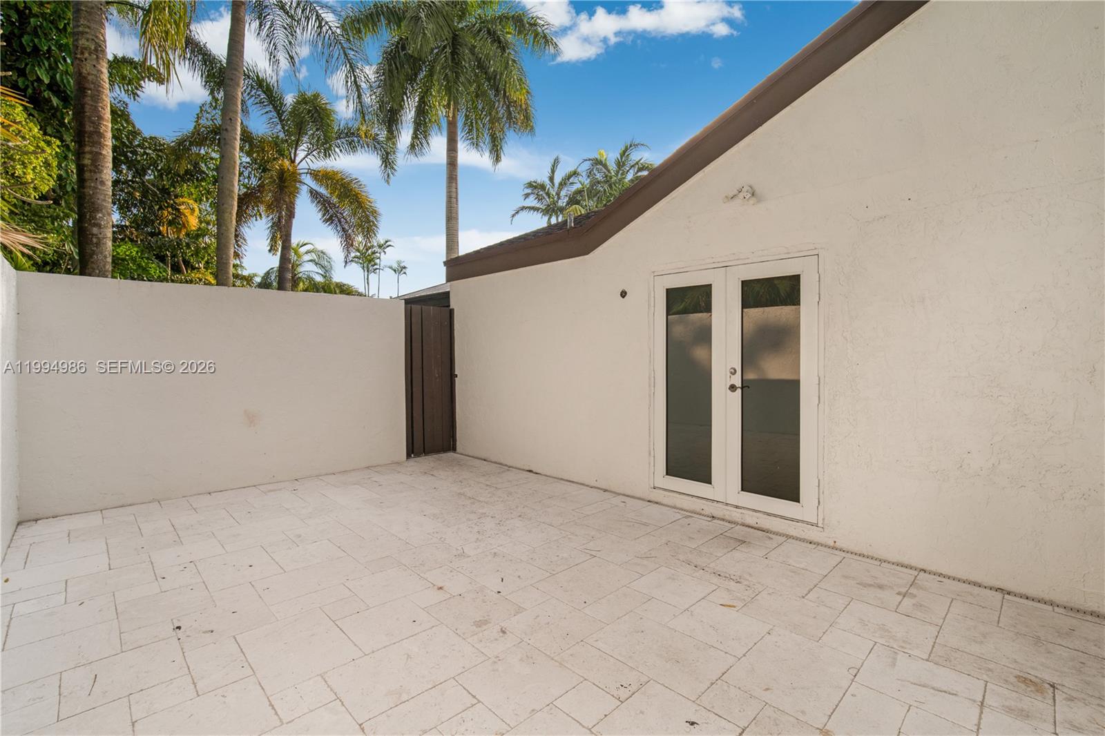 15250 Southwest 154th Terrace, Unit A Miami, FL 33187 - Photo 4 of 16 view of backyard with palm tree