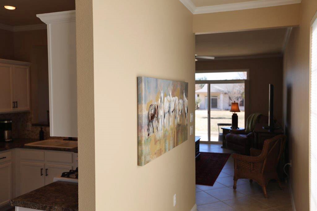 109 Ranier Lane Georgetown, TX 78633 - Photo 2 of 18 A well-appointed kitchen flows seamlessly into a luminous living area with a clear view of the backyard.