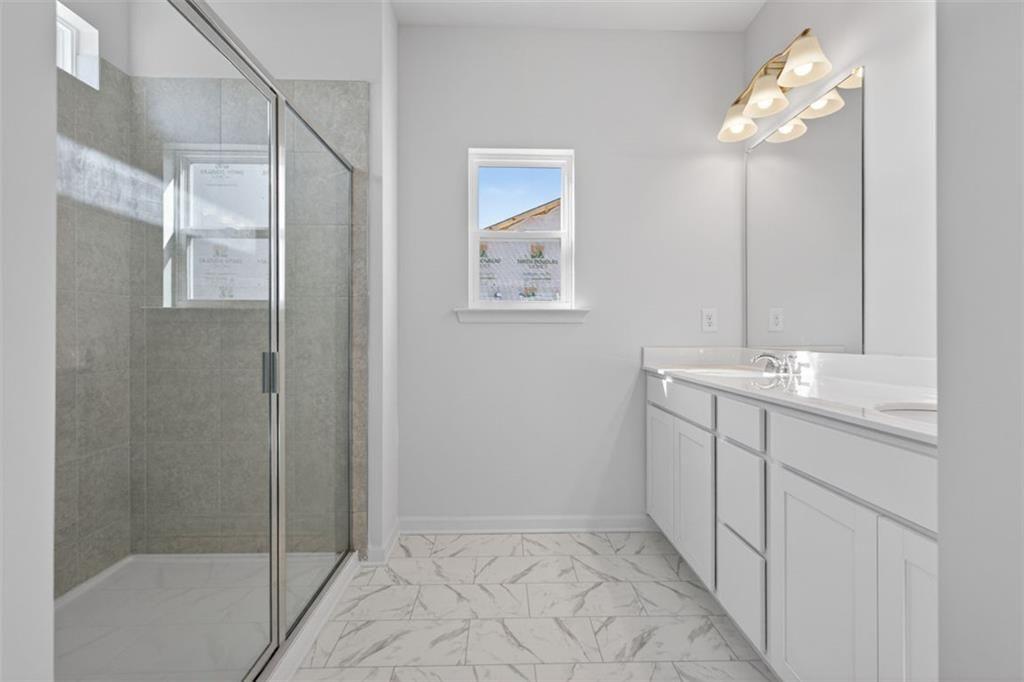 1007 Stiles Court, Unit 48 Cartersville, GA 30120 - Photo 28 of 34 a bathroom with a shower sink and mirror
