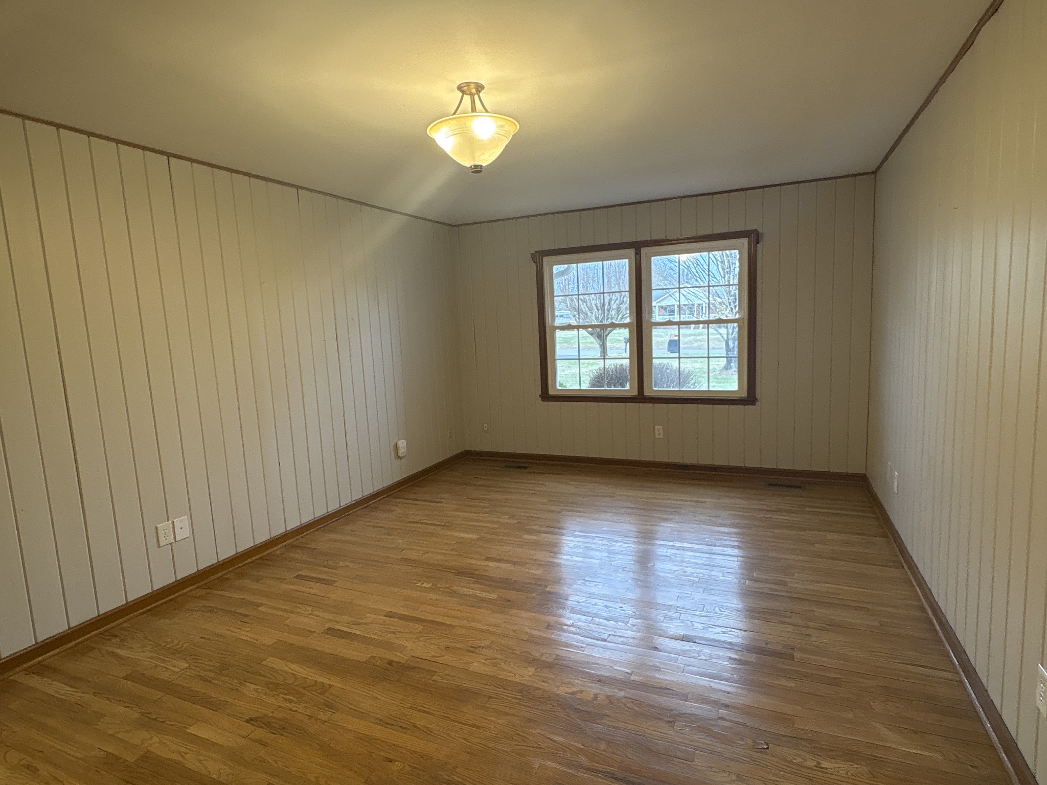 703 12 Oaks Road Tullahoma, TN 37388 - Photo 13 of 46 a view of an empty room with a window and wooden floor
