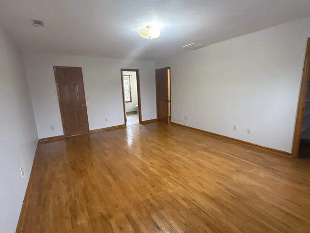 a view of walk in closet with empty racks