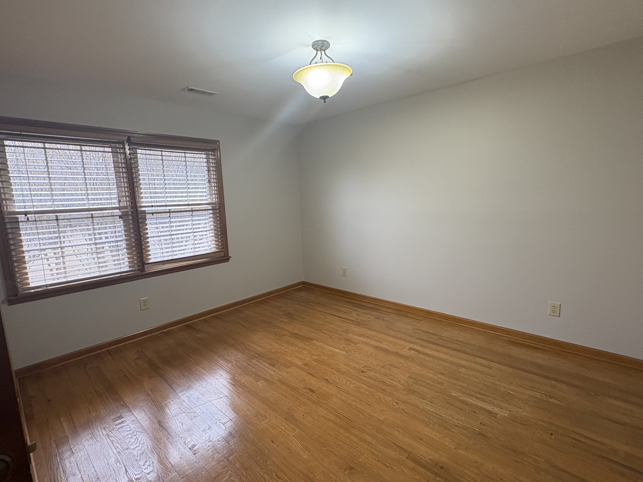 703 12 Oaks Road Tullahoma, TN 37388 - Photo 25 of 46 wooden floor in an empty room with a window