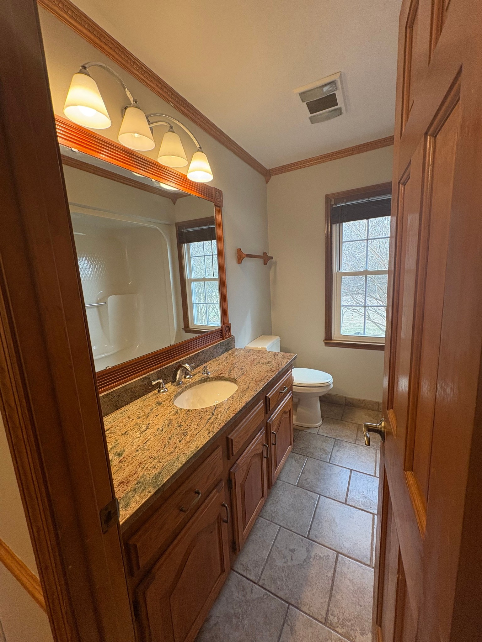 703 12 Oaks Road Tullahoma, TN 37388 - Photo 28 of 46 a bathroom with a granite countertop sink and a mirror