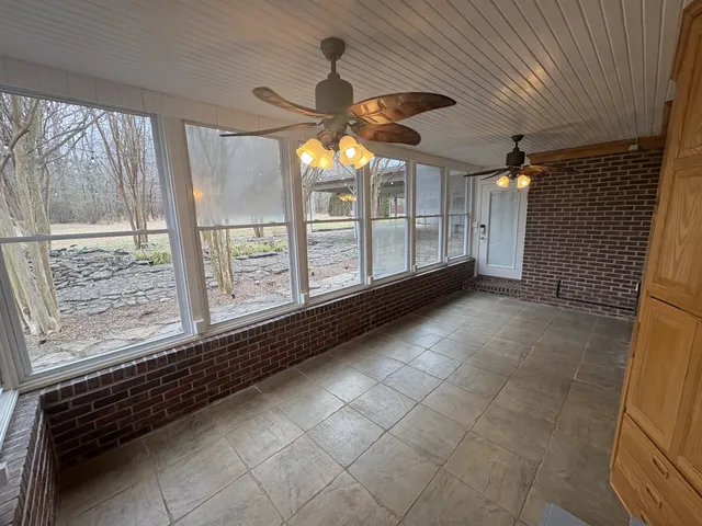 a view of a hallway with chandelier and fireplace