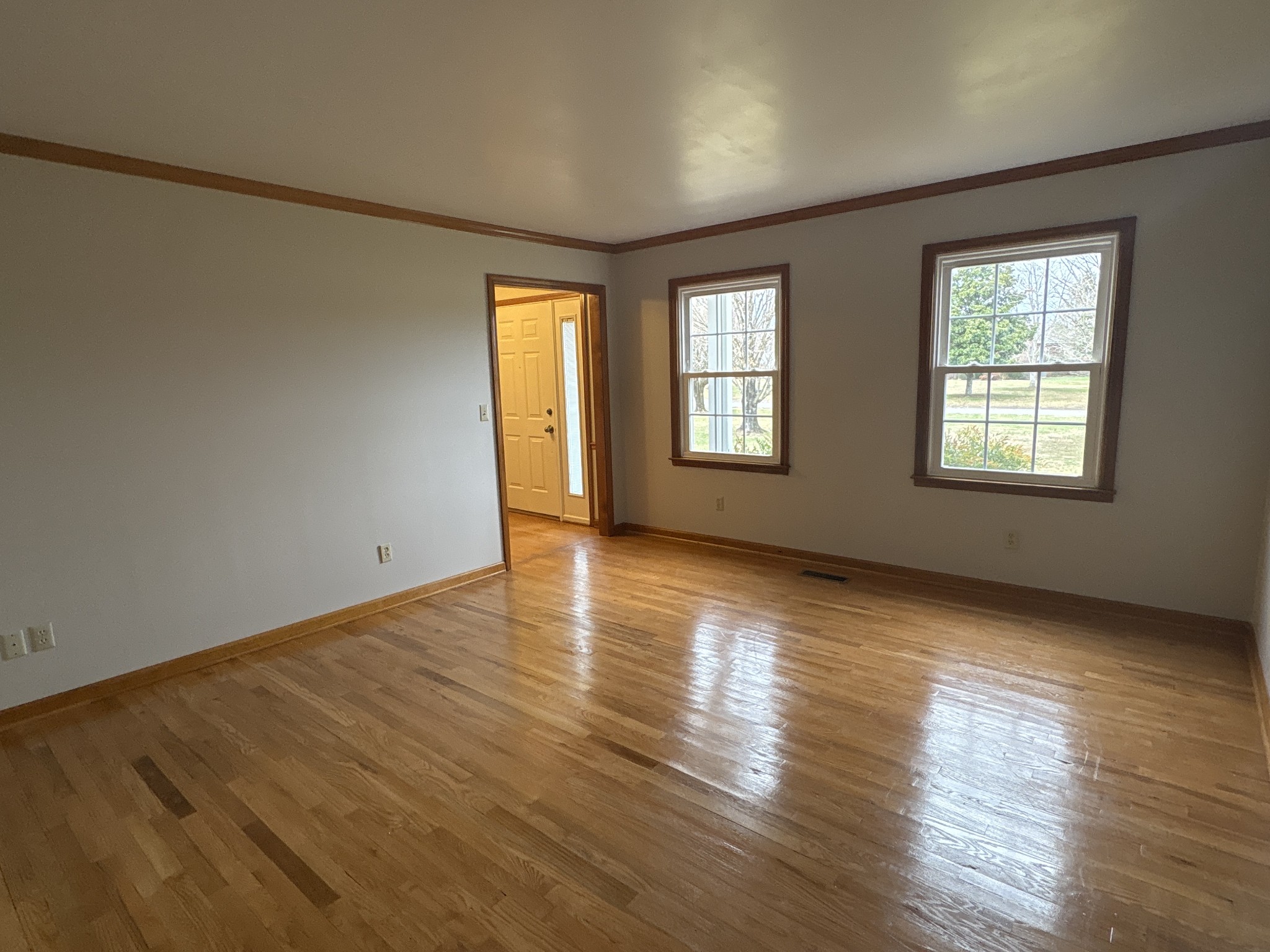 703 12 Oaks Road Tullahoma, TN 37388 - Photo 6 of 46 a view of an empty room with wooden floor and a window