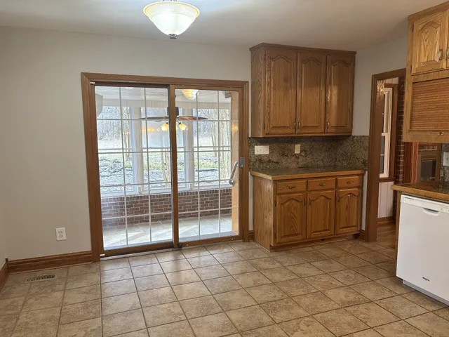 a kitchen with a wooden cabinets and a stove top oven