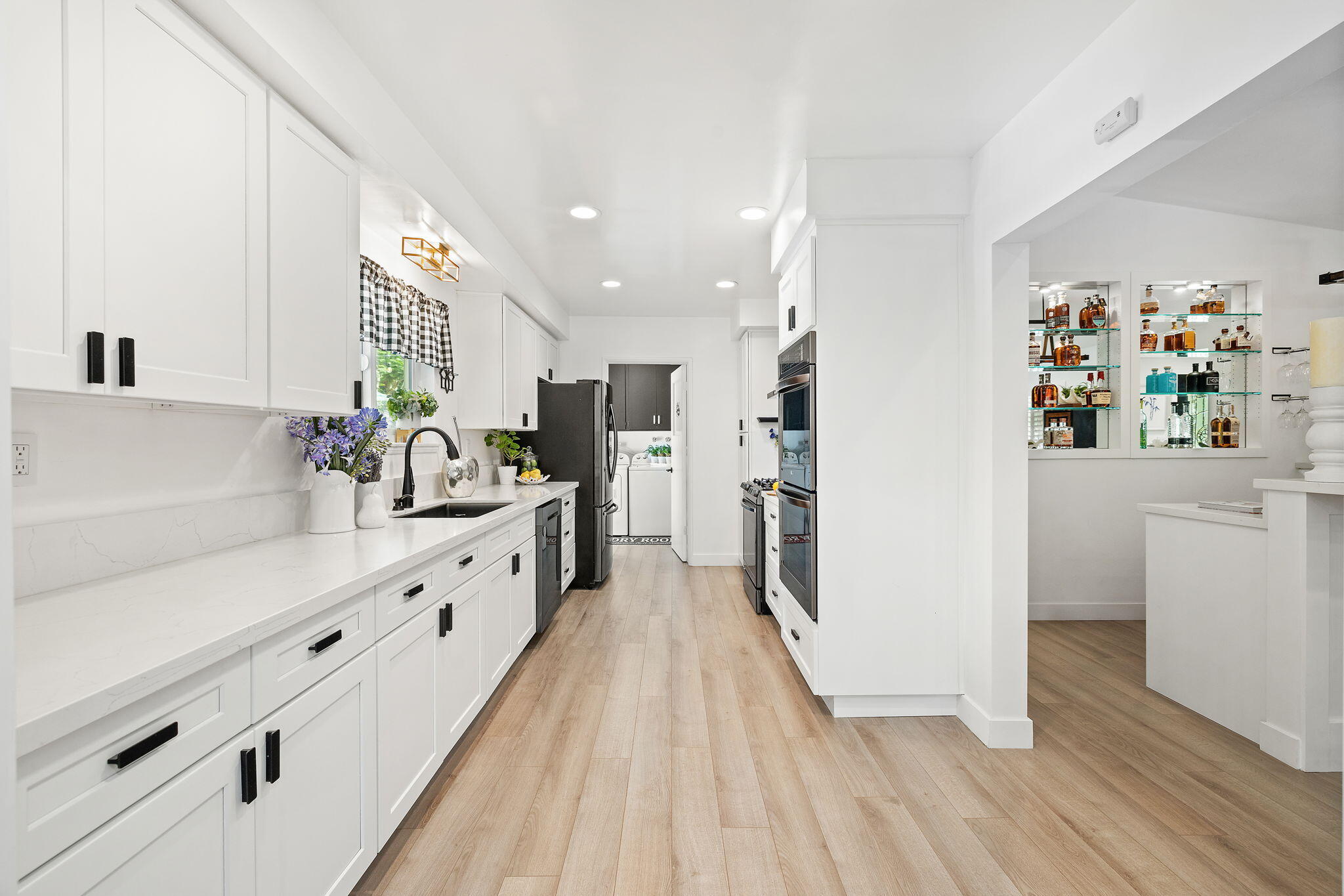 5853 Flambeau Road Rancho Palos Verdes, CA 90275 - Photo 13 of 32 a large white kitchen with a lot of counter space and wooden floor