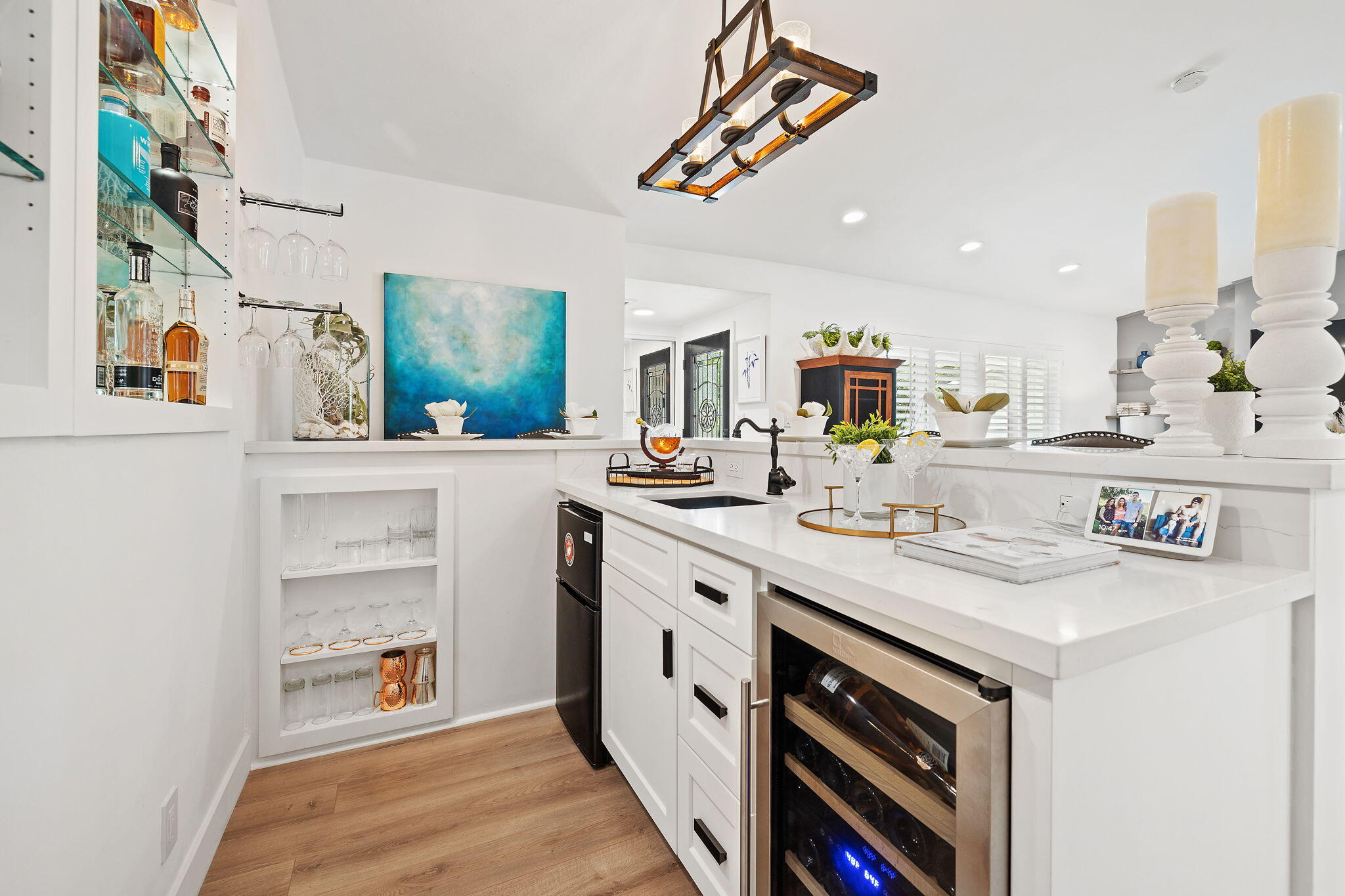 5853 Flambeau Road Rancho Palos Verdes, CA 90275 - Photo 15 of 32 a kitchen with a sink dishwasher and white cabinets with wooden floor