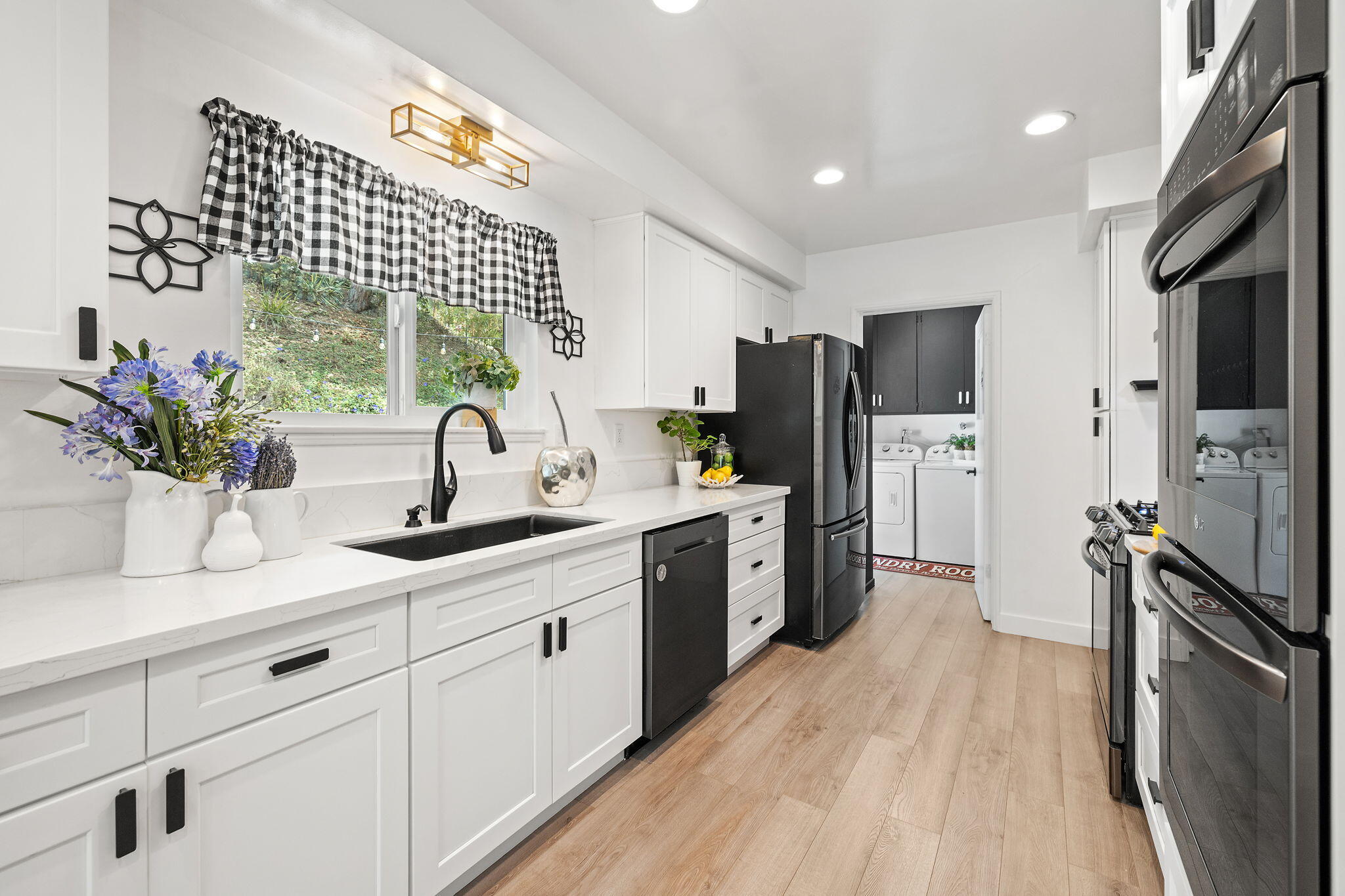 5853 Flambeau Road Rancho Palos Verdes, CA 90275 - Photo 10 of 32 a kitchen with a sink stainless steel appliances a counter top space cabinets and furniture