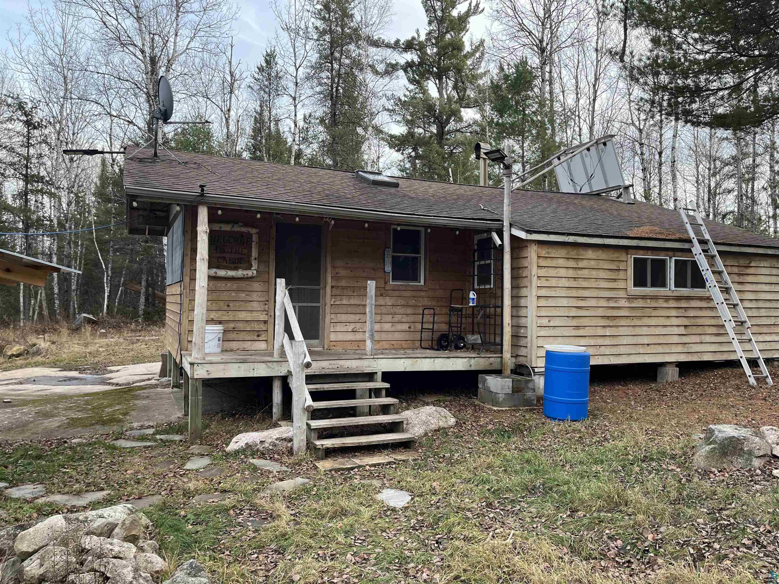 4002 Shilo Trail Ely, MN 55731 - Photo 1 of 15 View of front of property with a shingled roof and a wooden deck
