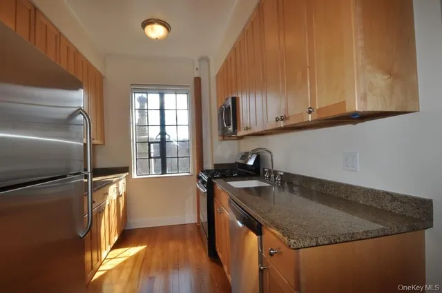 a kitchen with a sink a stove and cabinets