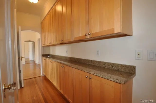 a kitchen with granite countertop white cabinets and sink