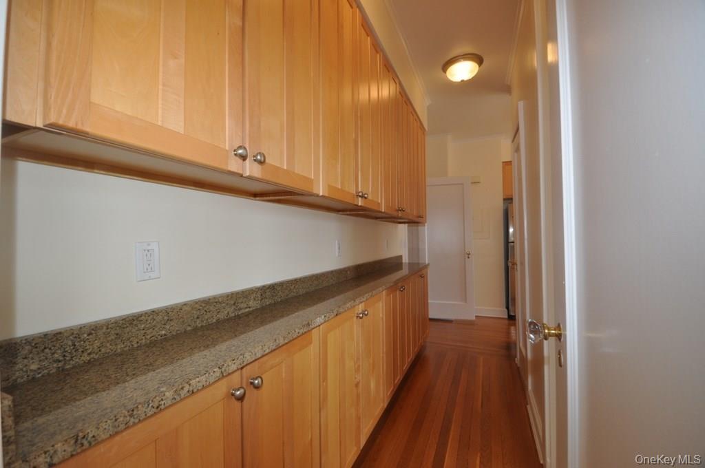 155 Garth Road, Unit 5H Scarsdale, NY 10583 - Photo 15 of 30 a kitchen with a sink and cabinets