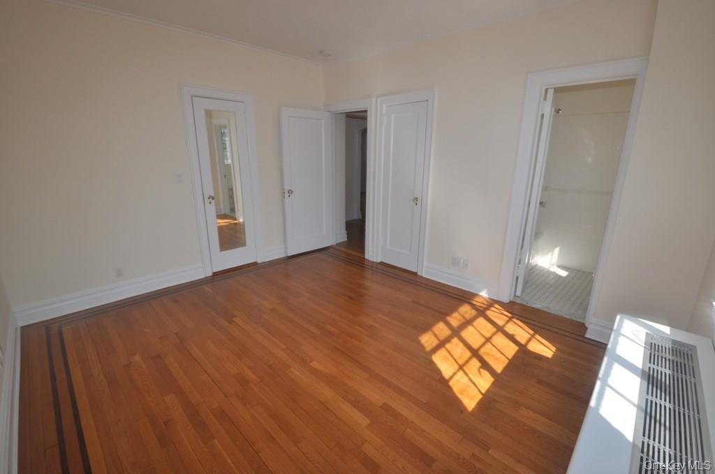 155 Garth Road, Unit 5H Scarsdale, NY 10583 - Photo 22 of 30 a view of an empty room and window