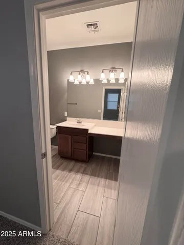 a en suite bathroom with a sink and a mirror