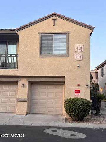 a front view of a house with garage