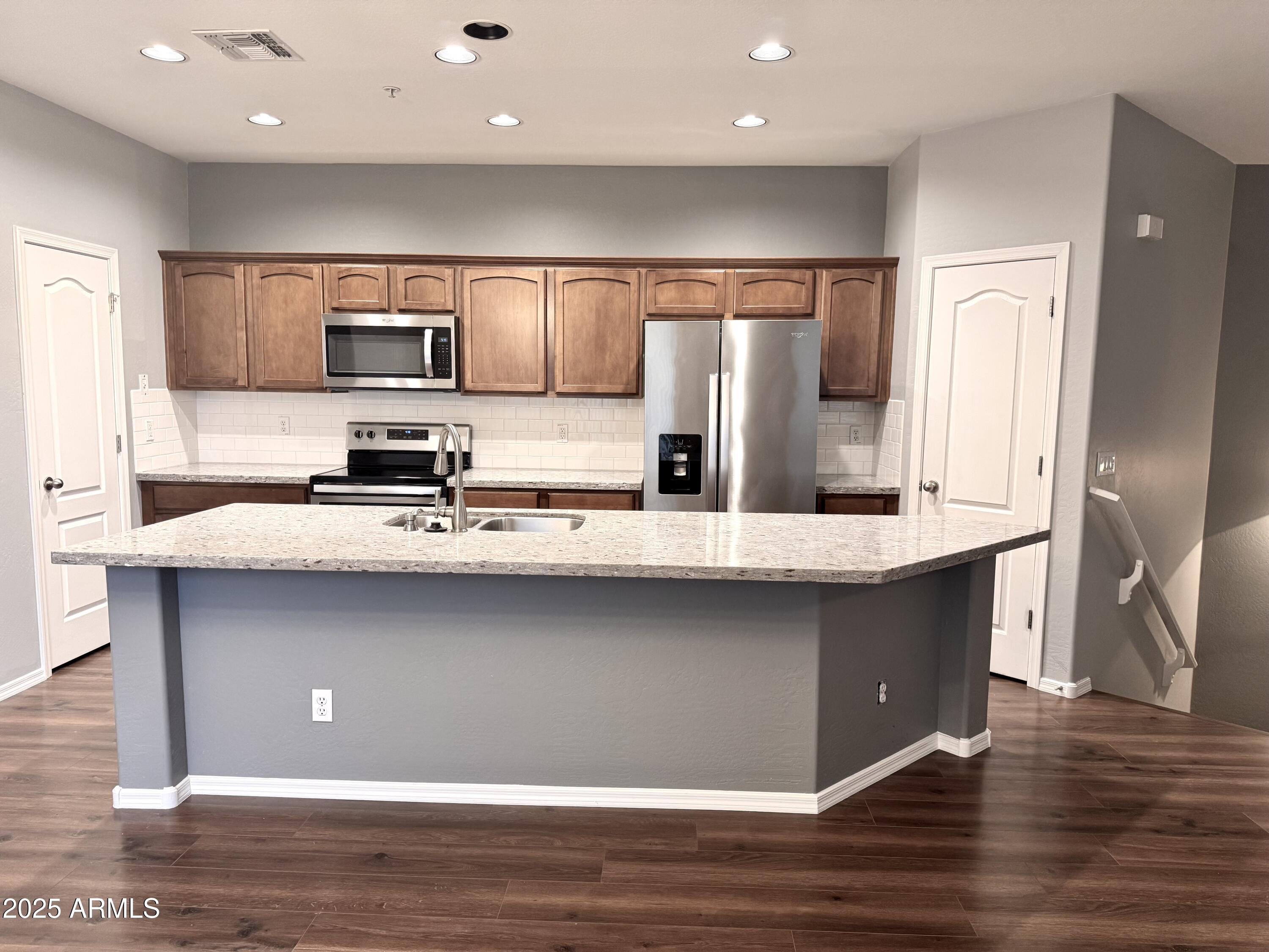 8130 West Groom Creek Road Phoenix, AZ 85043 - Photo 6 of 16 a kitchen with stainless steel appliances a sink refrigerator and microwave