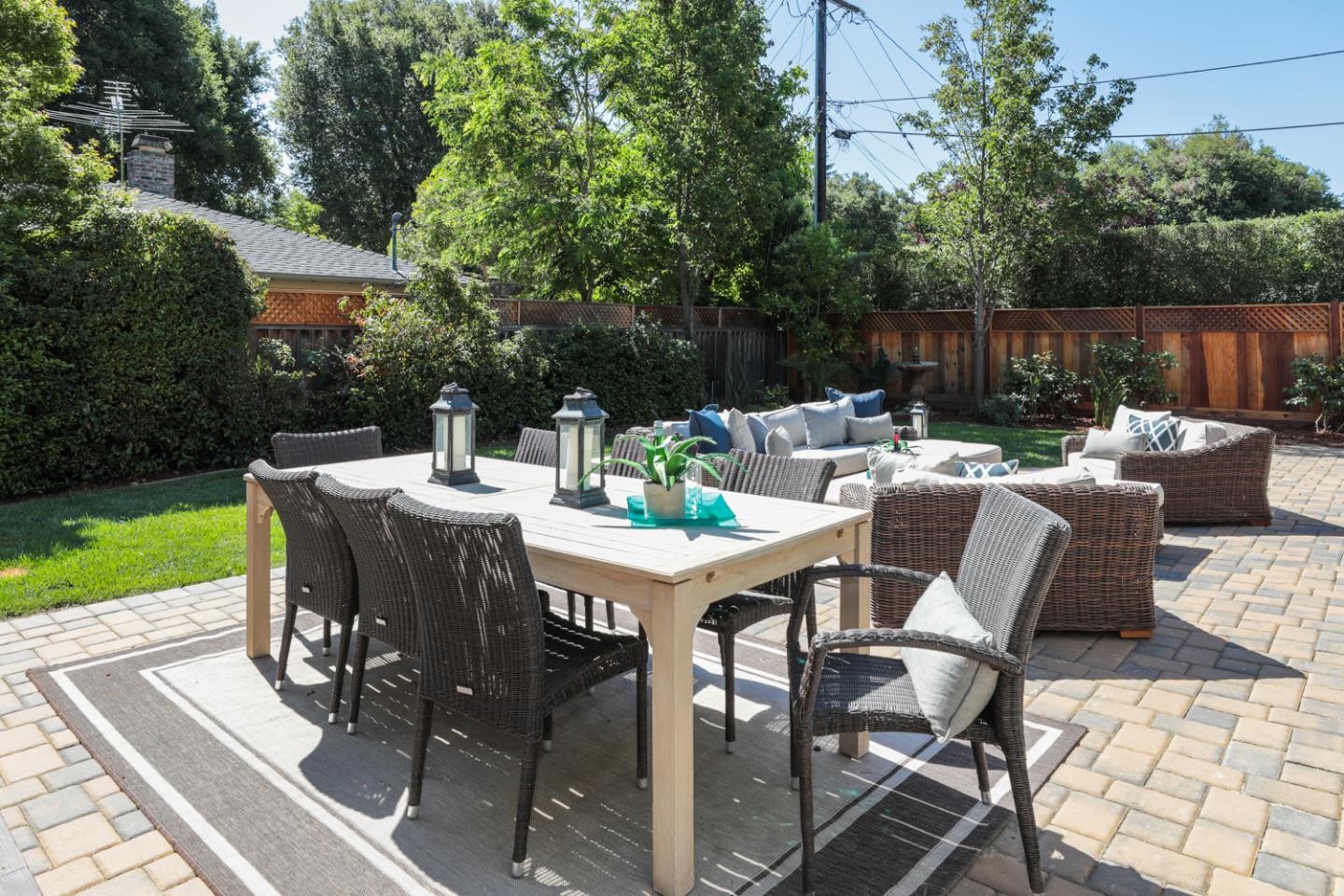 1202 Payne Drive Los Altos, CA 94024 - Photo 30 of 36 a view of a patio with table and chairs potted plants with wooden floor and fence