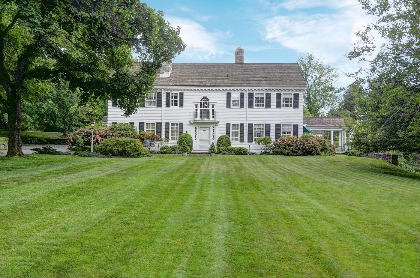 96 Woods End Road New Canaan, CT 06840 - Photo 3 of 21 a view of a house with a swimming pool